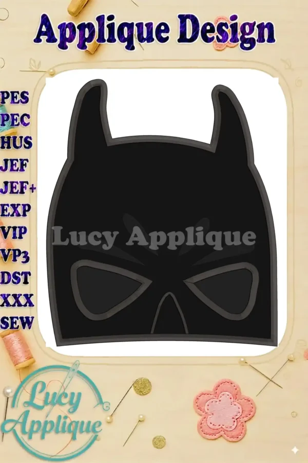 Embroidery design of a Batman head applique. The design is black with gray detailing, suitable for various fabrics. The image displays the applique design against a white background, with the artist's logo subtly placed in the corner.